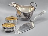 a silver plate with spoons and a bowl on the table