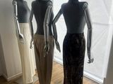 three mannequins are standing in a row in front of a window