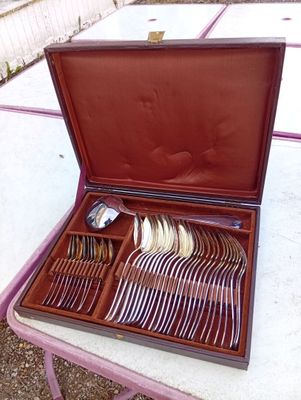 a wooden case with silverware in it on a table
