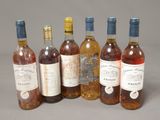 several bottles of wine are lined up on a table