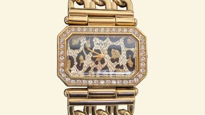 a gold watch with a leopard pattern on the face