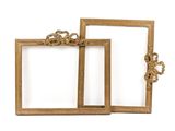 two gold picture frames sitting next to each other on a white surface