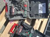 two tools that are sitting on a pallet on the ground