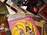 a lot of books on a table with a clock