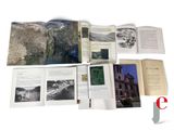 an open book with pictures of mountains and a river in it