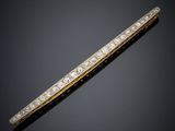 a gold and diamond bar broochle