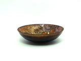a brown bowl that is sitting on a white surface