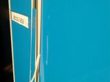 a blue refrigerator that is sitting in a room