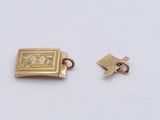 two pieces of gold plated metal with a picture of a man and a woman