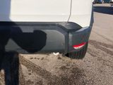 a white truck parked on the side of the road