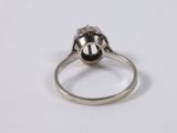 a close up of a silver ring with a black stone