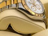 a watch that is sitting in a box on a pillow