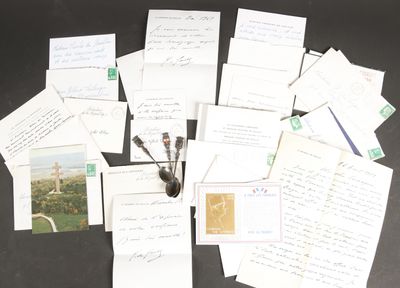 a pile of papers and a pen on a table