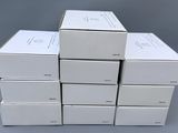 several white boxes stacked on top of each other on a gray surface