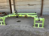 a close up of a large green machine in a garage
