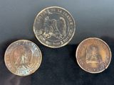 three different types of coins sitting on top of a black surface