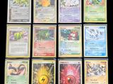 several pokemon cards are displayed on a black surface