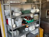 many dishes and pans on the shelves in the kitchen