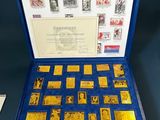 an open blue box containing a collection of stamps and stamps