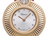 the watch is red and gold with diamonds on the face