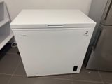 a small white refrigerator in the corner of a kitchen