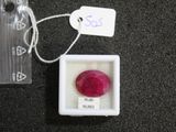 a small box with a red stone inside of it