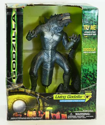 the godzilla action figure is in the box on the table