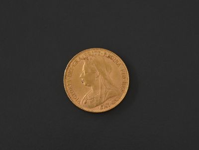 a close up of a gold coin on a black surface