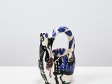 an image of a small vase with a cat on it