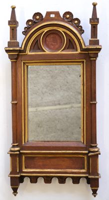 a mirror on the wall with a shelf above it