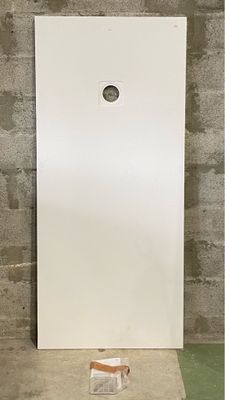 a white door with a hole in the middle of it