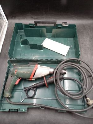 a green box with tools in it on a table