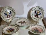 three plates with designs on them are sitting on a table