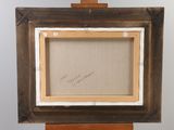 an old picture frame on a wooden easel with a painting on it