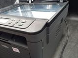 a printer that is sitting on the floor next to a monitor