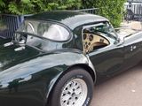 a green sports car parked on the side of the road