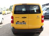 a yellow van that is parked in a parking lot