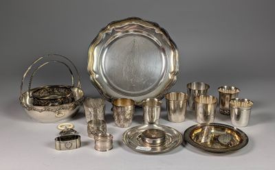 an assortment of silverplated items including a bowl, tray, cups, and other items