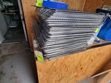 a pile of metal rods and a blue bag in a room