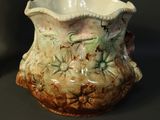 a vase that is sitting on a table next to a candle