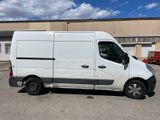 the white van is parked in the parking lot outside of the building