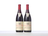 two bottles of red wine sitting next to each other on a table