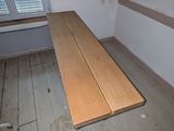 a wooden bench in the corner of a room