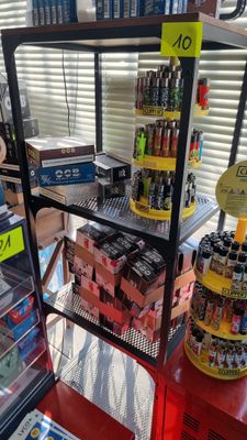 a woman standing in front of a display case of drinks