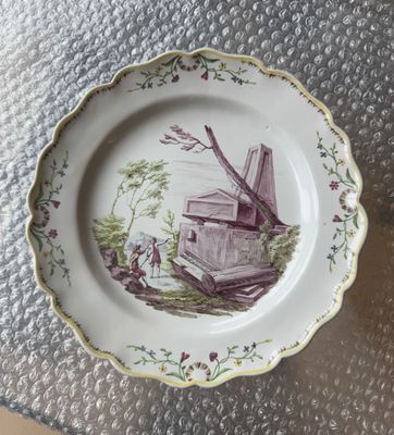 a plate with a windmill on it on a table