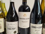 several bottles of wine are lined up in a row on a table