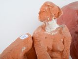a clay sculpture of a man and a woman sitting next to each other