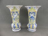 two vases with blue and yellow designs on them