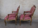 pair of pink velvet upholstered chairs with gold trim