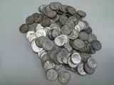 une pile de pièces d'argent posée sur une table blanche